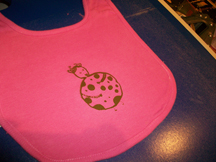 Gas Girl screen printed on a baby bib