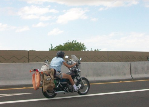 A man on his bike with his dog